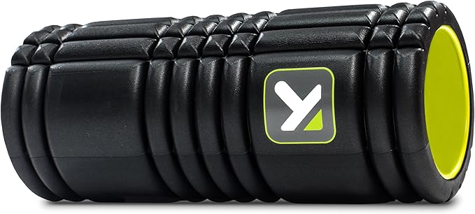 A person using a multi-density foam roller for a sore back to massage and release tight muscles.