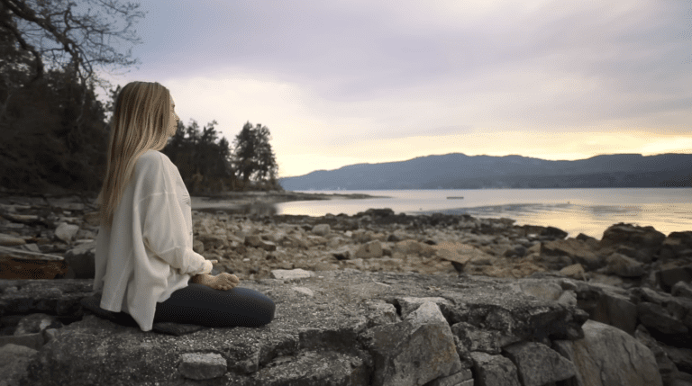 A person is calmly sitting in a peaceful room, practicing the best morning mindfulness meditation routine.