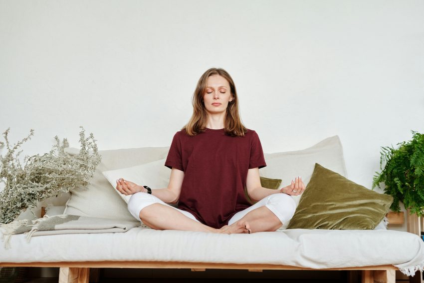 A person is calmly sitting in a peaceful room, practicing the best morning mindfulness meditation routine.