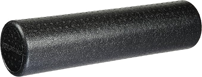 A person finds relief by using a high-density foam roller for lower back pain on a yoga mat.