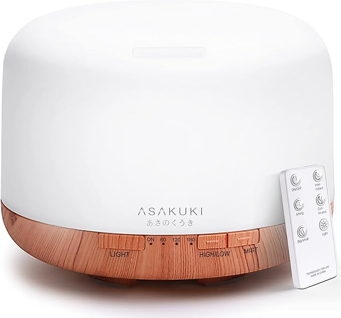 A white and wood grain ultrasonic essential oil diffuser emits a cool mist for a relaxing home atmosphere.