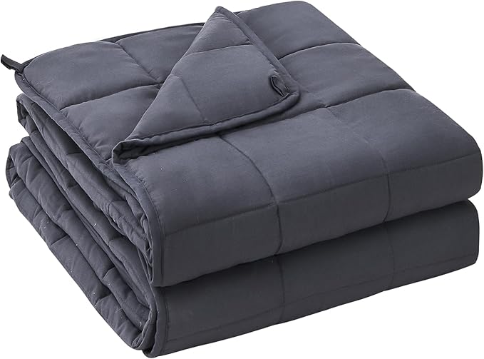 A cozy weighted blanket for sleep issues spread across a bed.