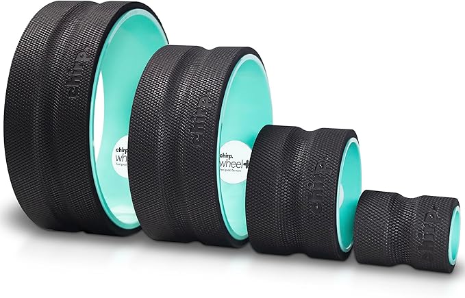 A person finds relief by using a high-density foam roller for lower back pain on a yoga mat.